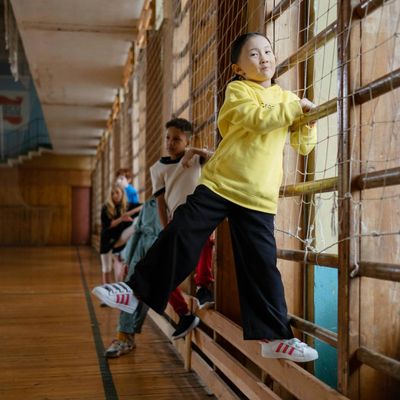 A pair of athletic shoes on a clean wooden floor.