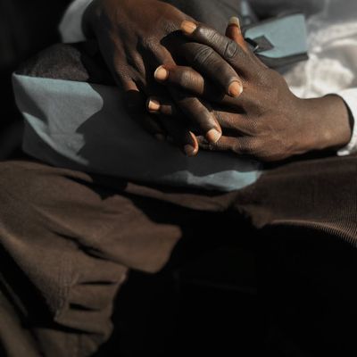 A person's hands resting on their knees during a meditation moment.