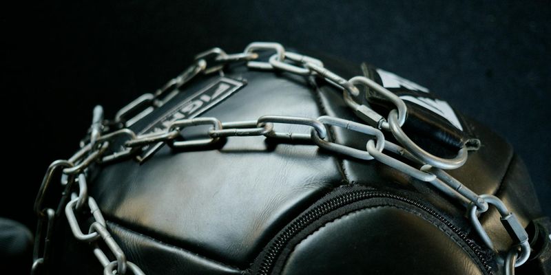 Close-up of a textured grip on a black dumbbell.
